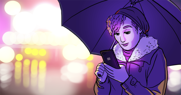 Cô gái sử dụng điện thoại di động trên đường trong khi cầm ô